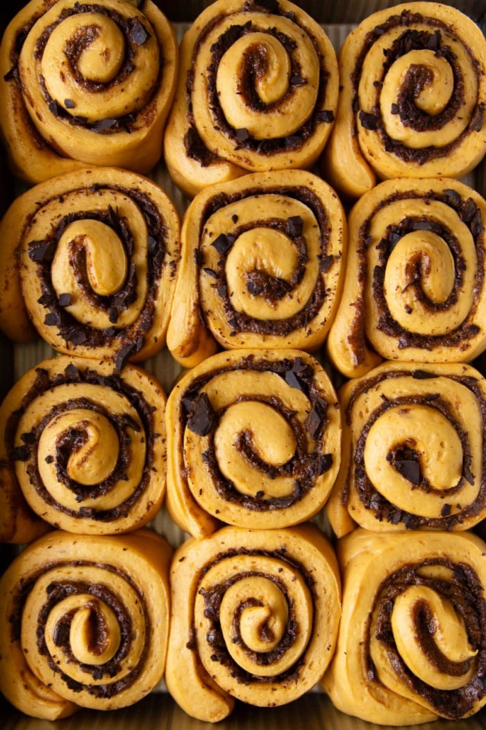proofed pumpkin yeast roll in baking pan.