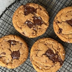 four cookies on black wire rack.