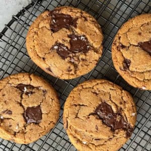 four cookies on black wire rack.