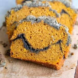close up showing the distinct layers of pumpkin cake, black sesame filling, and black sesame crumble.